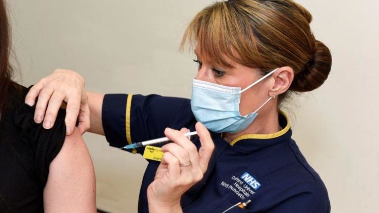 a nurse administering a vaccine